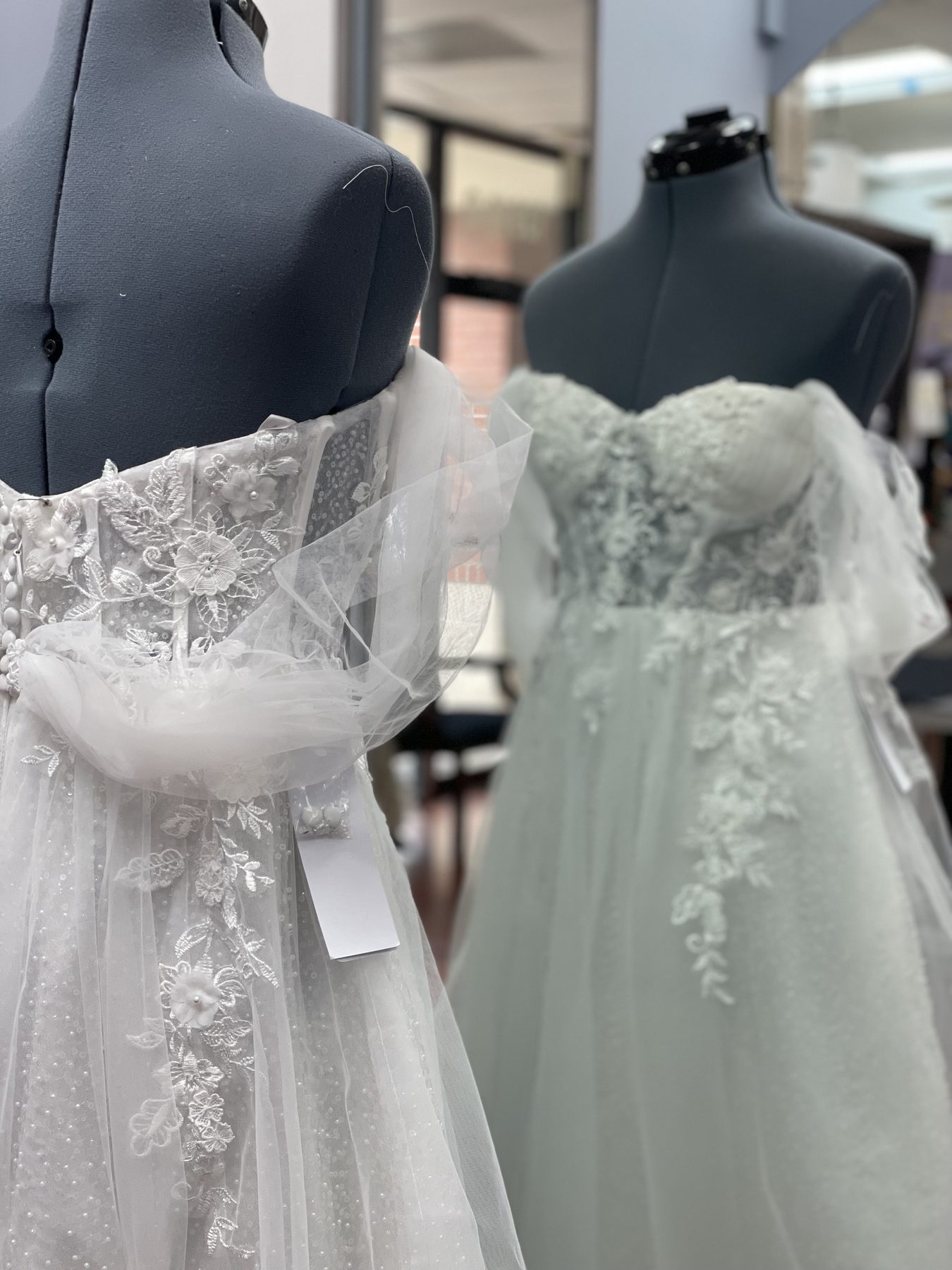Two custom bridal gowns, fresh from a wedding dress alteration fitting